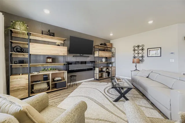 a living room with furniture cabinets and a flat screen tv