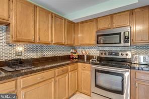 17 Devon Court Sterling, VA 20165 - Photo 13 of 30 a kitchen with granite countertop cabinets stainless steel appliances and a sink