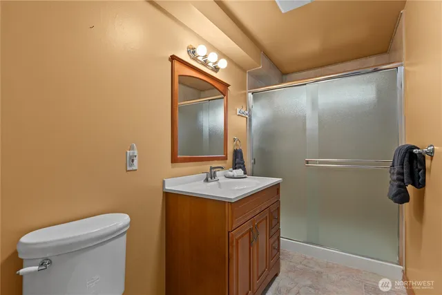 a bathroom with a sink toilet and shower