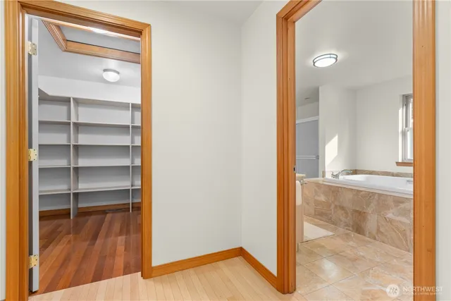 a view of a room with wooden floor and windows