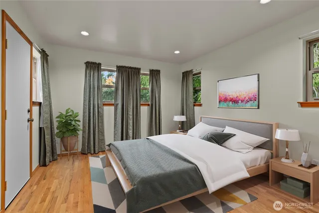 a spacious bedroom with a bed and a flat screen tv