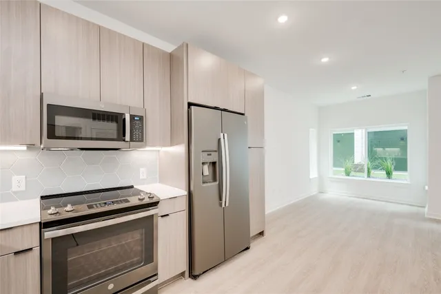 a kitchen with a stove microwave and refrigerator