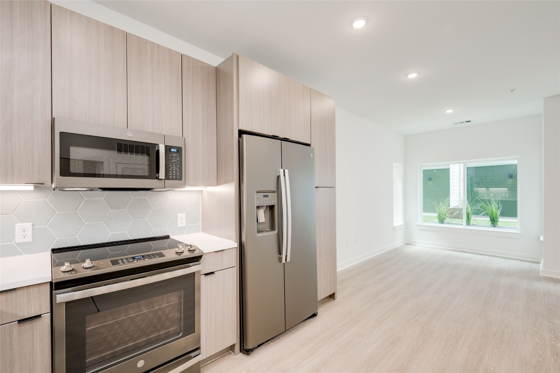 4802 South Congress Avenue, Unit 121 Austin, TX 78745 - Photo 17 of 38 a kitchen with a stove microwave and refrigerator