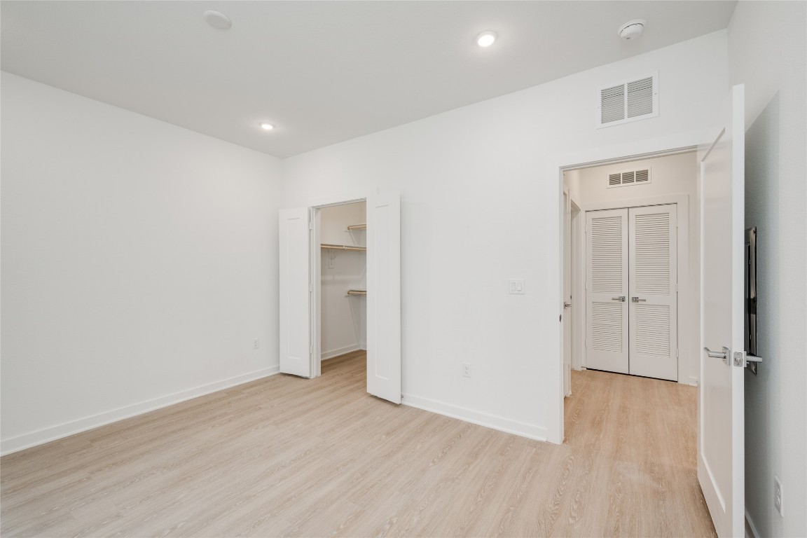 4802 South Congress Avenue, Unit 121 Austin, TX 78745 - Photo 20 of 38 wooden floor in an empty room with a window