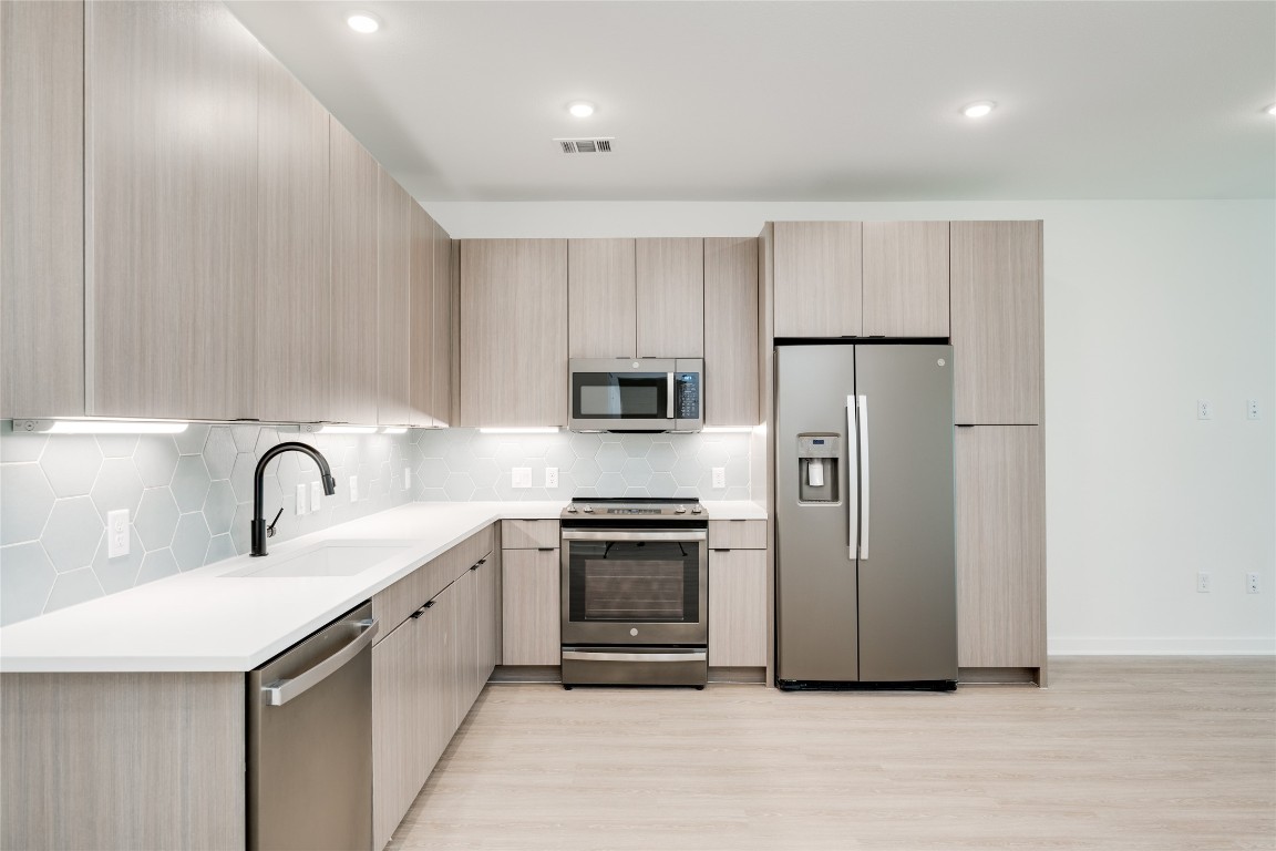 4802 South Congress Avenue, Unit 121 Austin, TX 78745 - Photo 2 of 38 a kitchen with stainless steel appliances granite countertop a refrigerator sink and stove