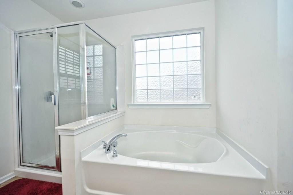9927 Paxton Run Road Charlotte, NC 28277 - Photo 16 of 24 a white bath tub sitting next to a window