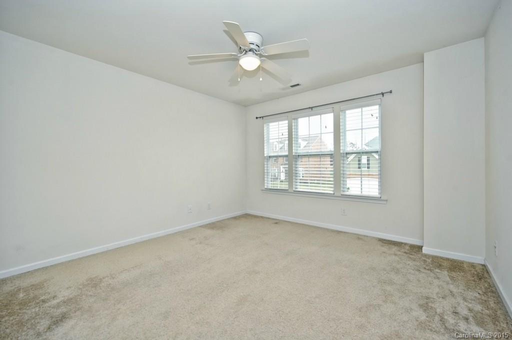 9927 Paxton Run Road Charlotte, NC 28277 - Photo 17 of 24 an empty room with a window and a ceiling fan
