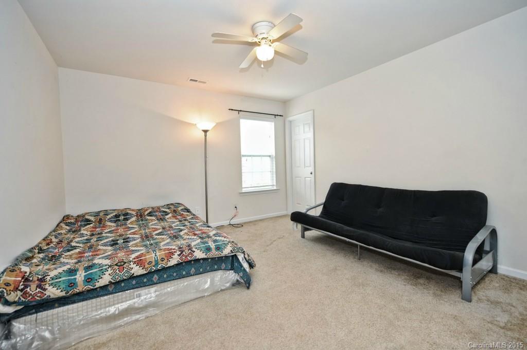 9927 Paxton Run Road Charlotte, NC 28277 - Photo 19 of 24 a bedroom with a bed a window and a chandelier
