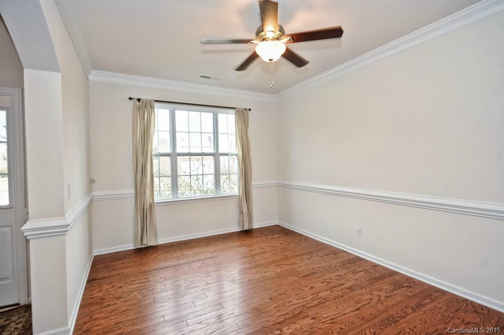 9927 Paxton Run Road Charlotte, NC 28277 - Photo 3 of 24 an empty room with wooden floor fan and windows