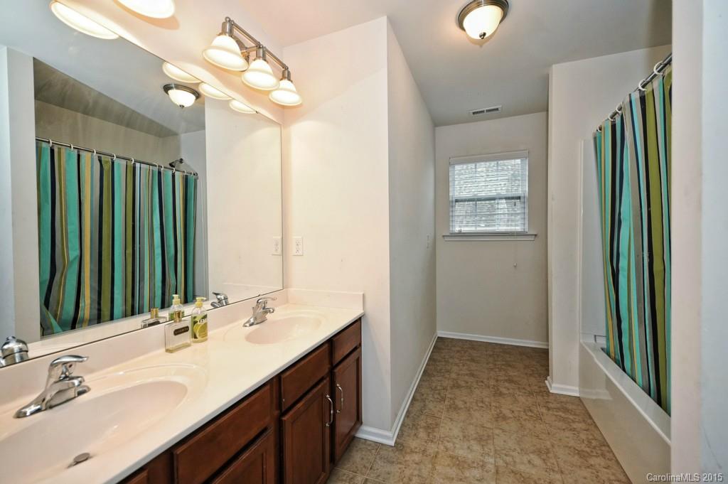 9927 Paxton Run Road Charlotte, NC 28277 - Photo 21 of 24 a bathroom with a double vanity sink and a mirror
