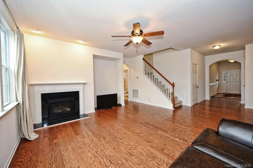 9927 Paxton Run Road Charlotte, NC 28277 - Photo 4 of 24 a view of a livingroom with wooden floor and a fireplace