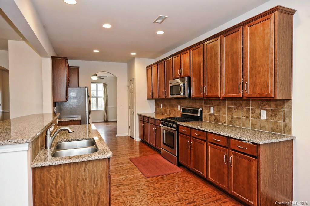 9927 Paxton Run Road Charlotte, NC 28277 - Photo 6 of 24 a kitchen with stainless steel appliances granite countertop a sink stove and refrigerator
