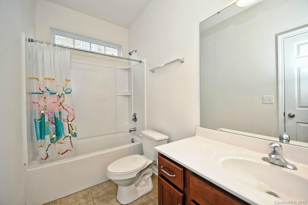 9927 Paxton Run Road Charlotte, NC 28277 - Photo 10 of 24 a bathroom with a sink a toilet a mirror a bathtub and shower