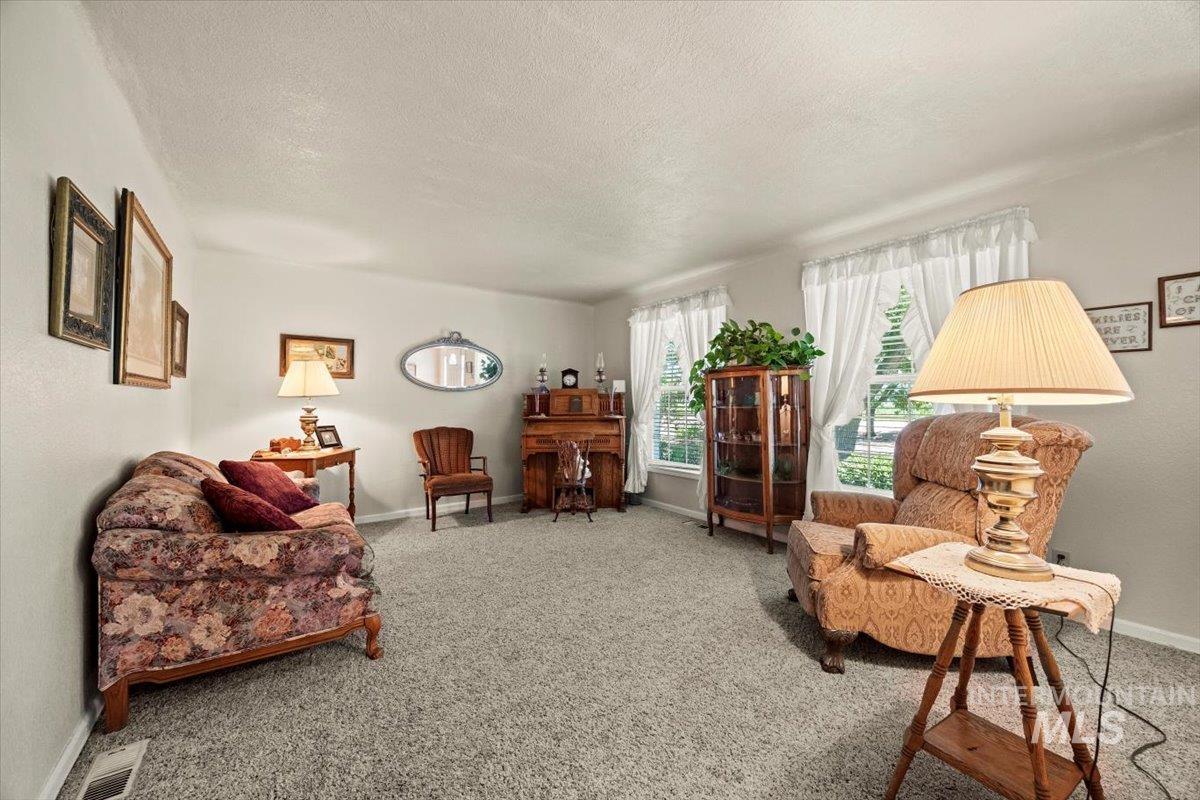 7425 Robinson Road Kuna, ID 83634 - Photo 13 of 50 Living room with a textured ceiling and carpet flooring