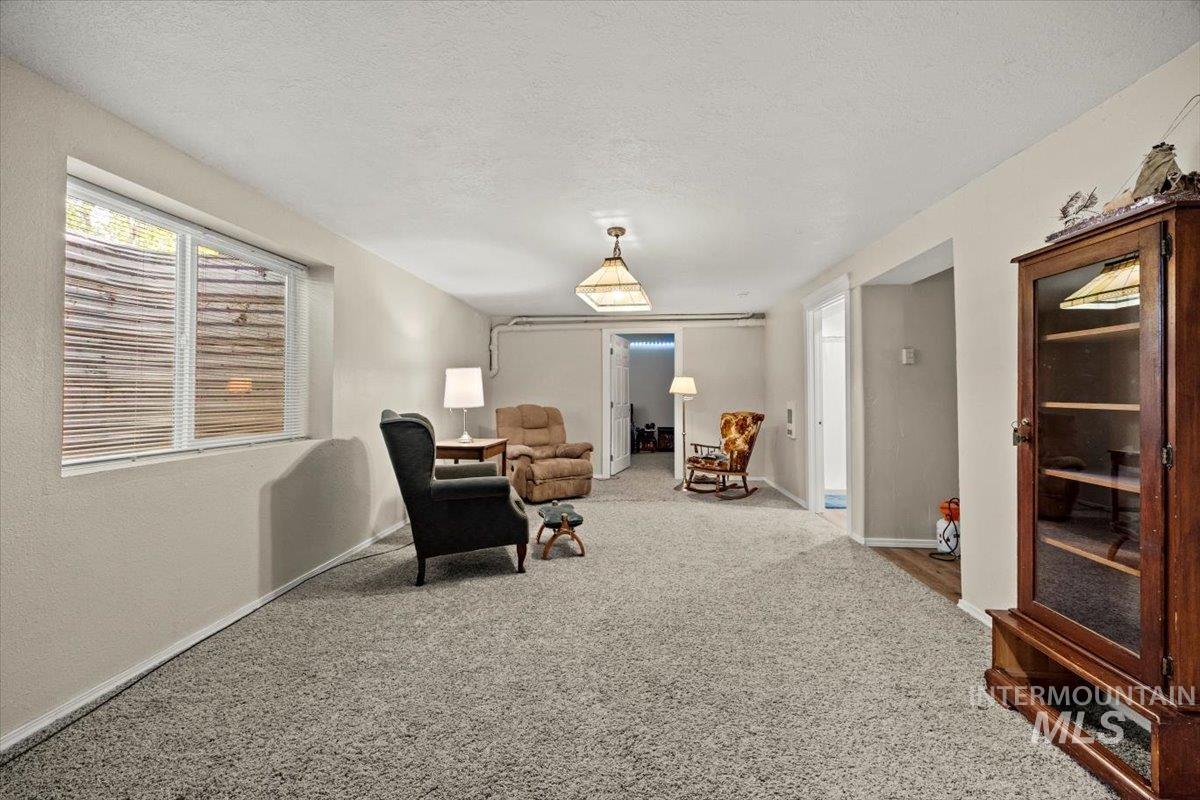 7425 Robinson Road Kuna, ID 83634 - Photo 39 of 50 Living area with carpet flooring and a textured ceiling