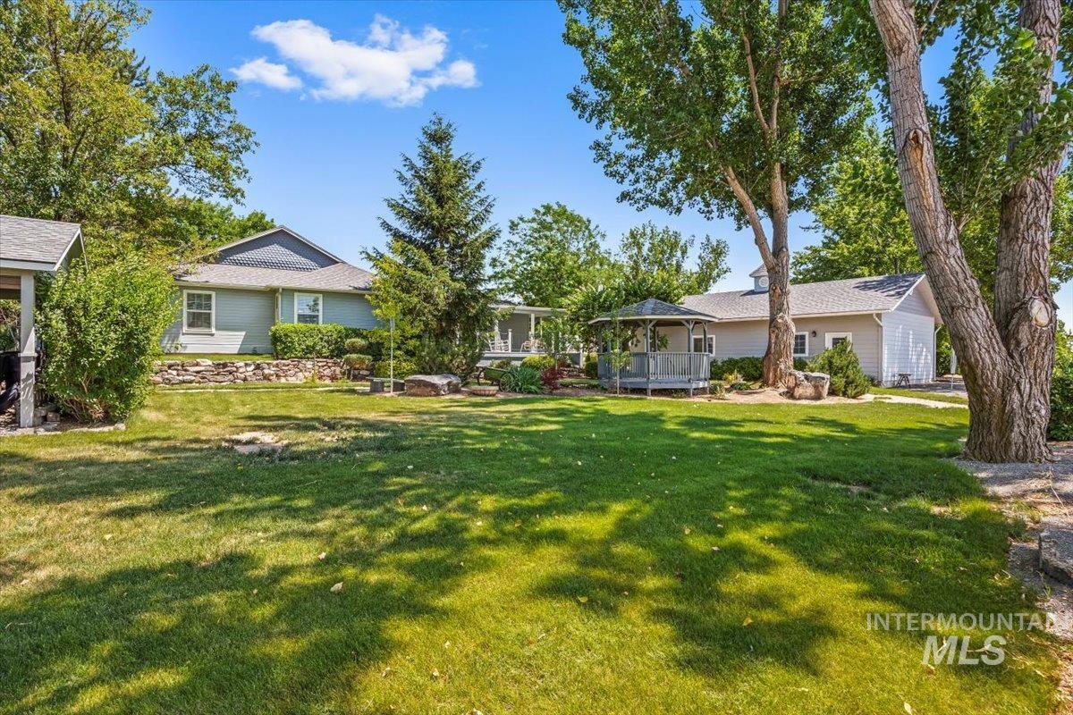 7425 Robinson Road Kuna, ID 83634 - Photo 48 of 50 View of grassy yard featuring a gazebo and a wooden deck