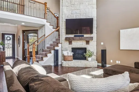 a living room with fireplace furniture and a flat screen tv