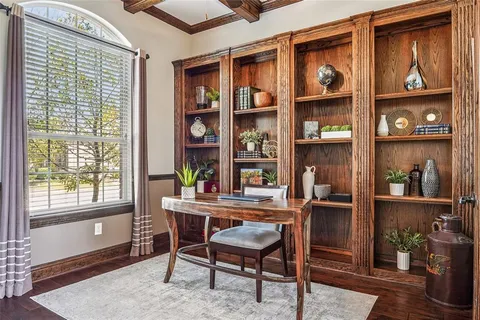 a view of a workspace with furniture and a window