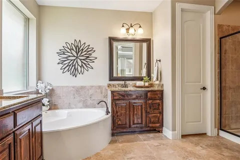 a bathroom with a bathtub sink and mirror