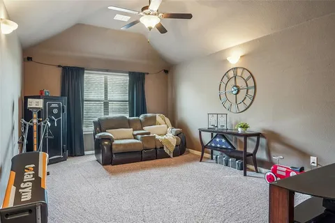 a living room with furniture a chandelier and a window