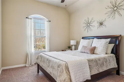 a bedroom with a large bed and a window