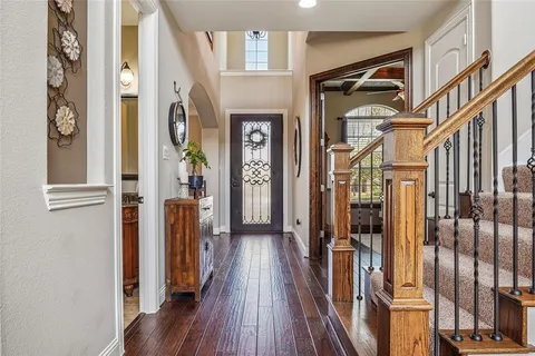 a view of hallway with wooden floor and stairs