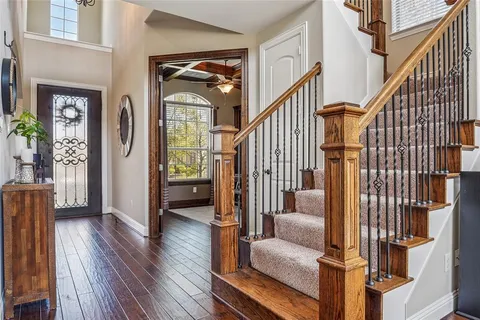 a view of an entryway with wooden floor and livingroom