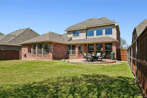 a front view of a house with swimming pool having outdoor seating