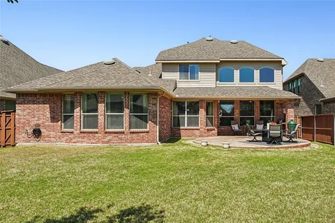 a front view of a house with a yard table and chairs