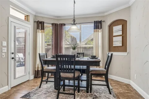 a dining room with furniture a chandelier and wooden floor