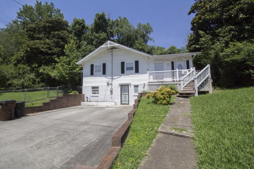 112 Delmar Circle Oak Ridge, TN 37830 - Photo 1 of 32 a front view of a house with a yard and trees