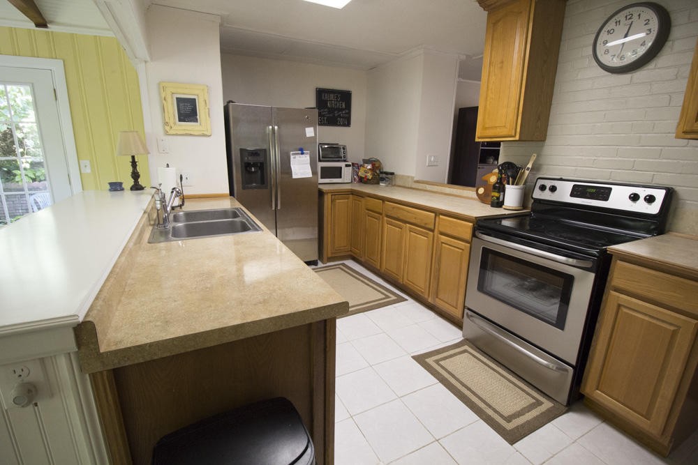 112 Delmar Circle Oak Ridge, TN 37830 - Photo 21 of 32 a kitchen with stainless steel appliances a stove a sink and a refrigerator