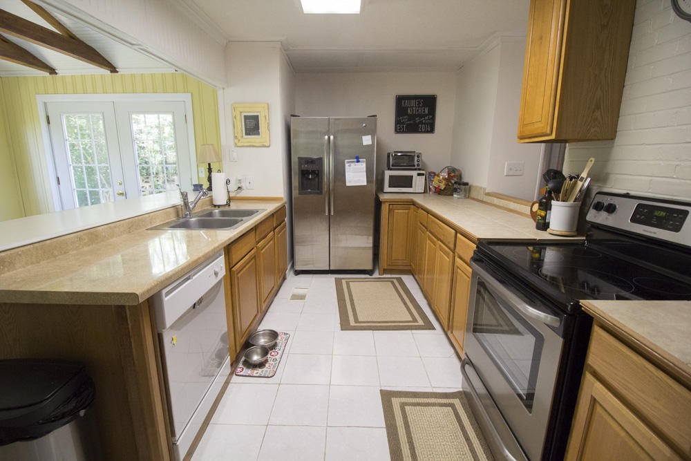 112 Delmar Circle Oak Ridge, TN 37830 - Photo 24 of 32 a kitchen with stainless steel appliances granite countertop sink stove and refrigerator