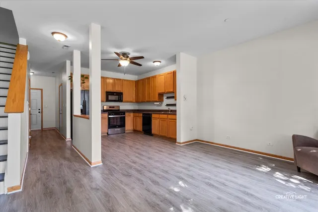 a view of kitchen with stainless steel appliances cabinets and wooden floor