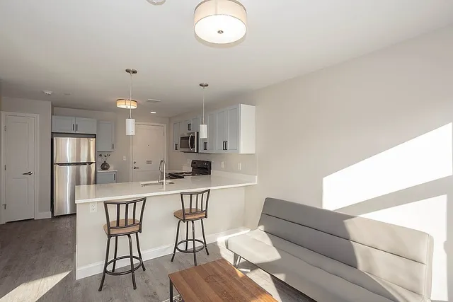 a view of kitchen with cabinets stainless steel appliances
