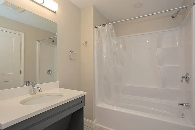 a bathroom with a sink mirror toilet and bathtub