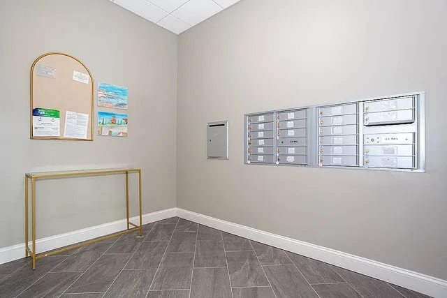 an empty room with windows and mirror