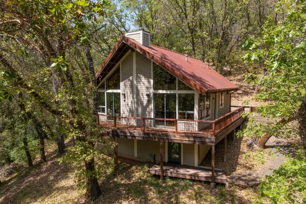 a view of house with a yard and sitting area