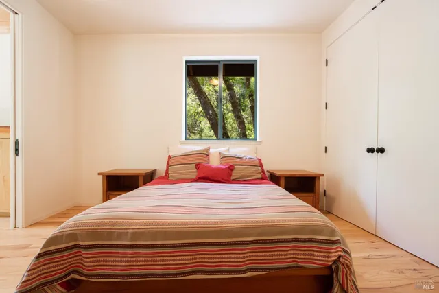 a bedroom with a bed and a window