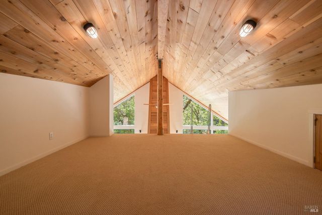a view of an empty room with a fireplace and a large window