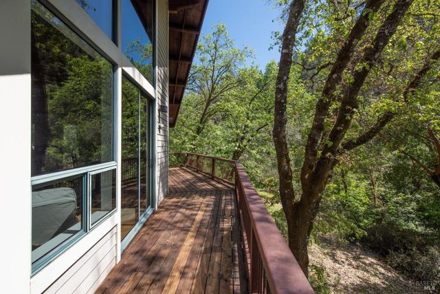 a view of balcony with wooden floor and fence