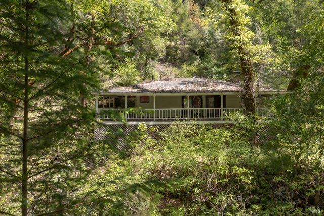 an aerial view of residential house with space and trees all around