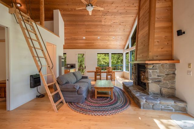 a living room with furniture a fireplace and a large window