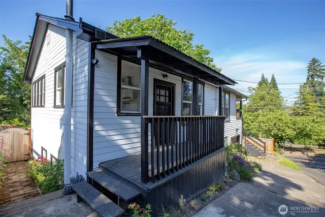 a view of a house with wooden fence