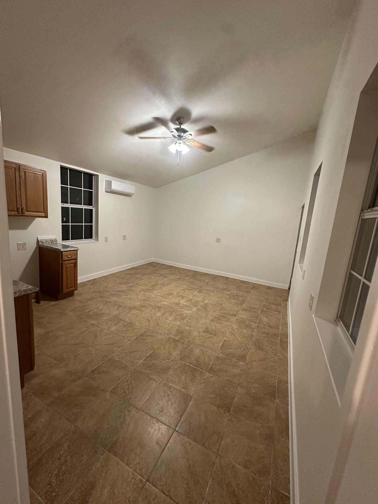 176 Old Lexington Road, Unit C Elgin, TX 78621 - Photo 28 of 31 an empty room with chandelier fan and windows
