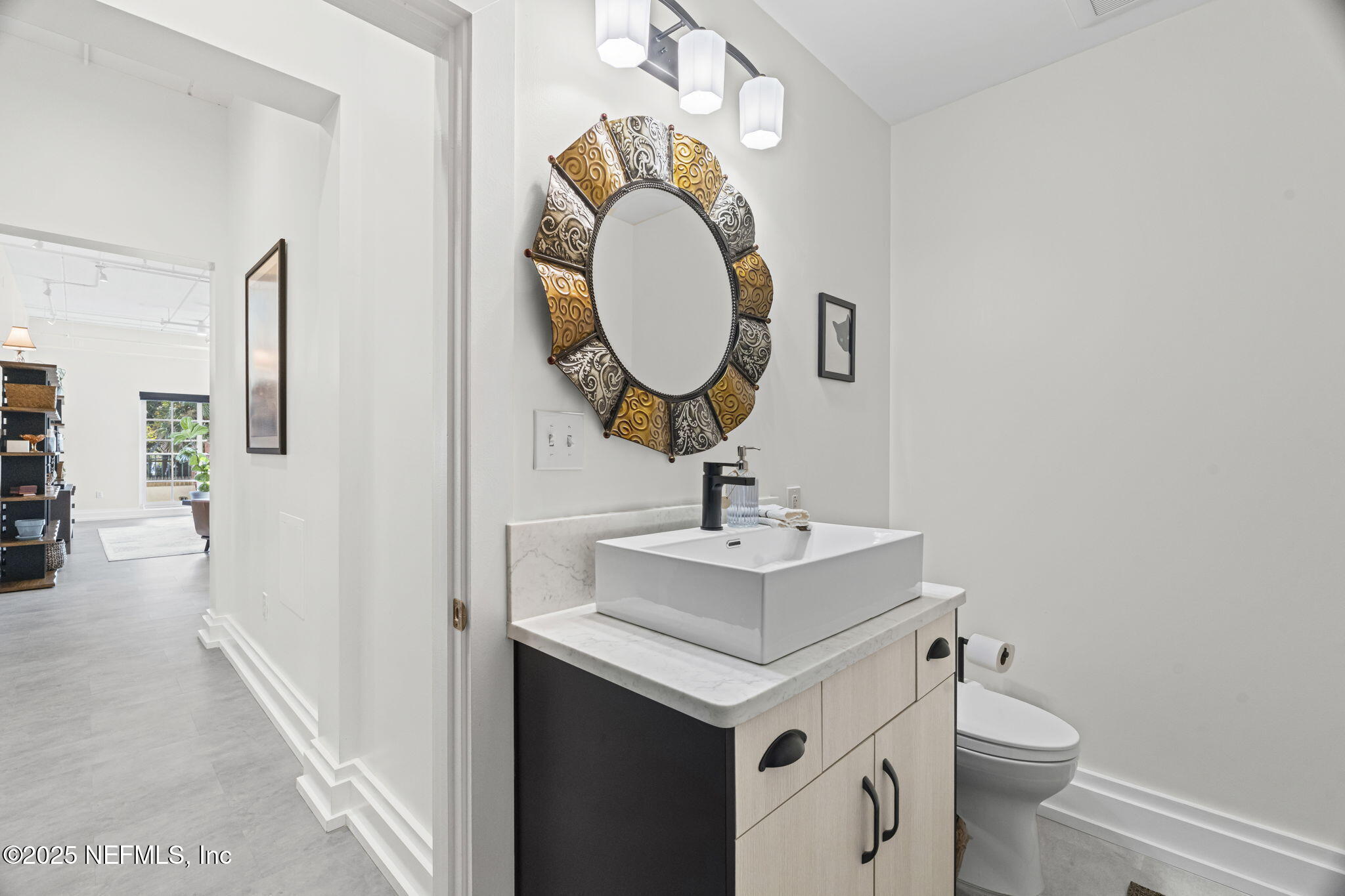 1661 Riverside Avenue, Unit 214 Jacksonville, FL 32204 - Photo 11 of 96 a bathroom with a toilet sink and mirror