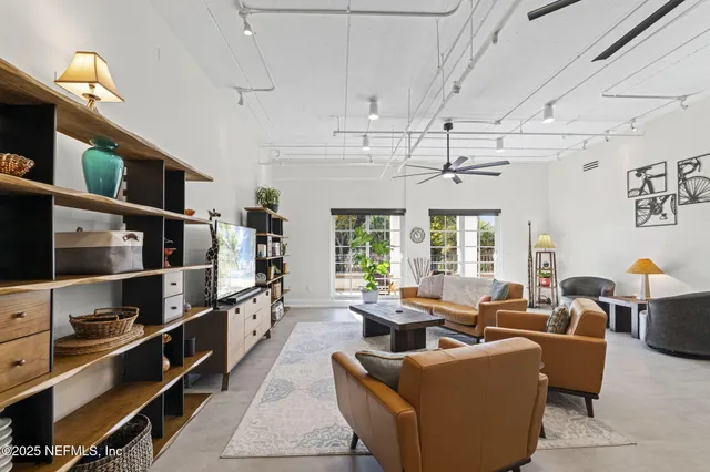 a kitchen with stainless steel appliances a dining table and chairs
