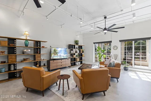 a kitchen with stainless steel appliances kitchen island granite countertop a sink a stove and refrigerator