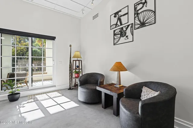 a kitchen with stainless steel appliances a sink a stove a refrigerator cabinets and wooden floor