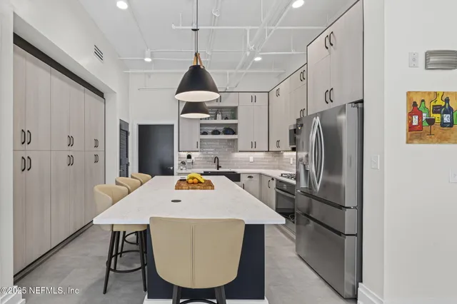 a bedroom with a bed and a flat tv screen next to a window
